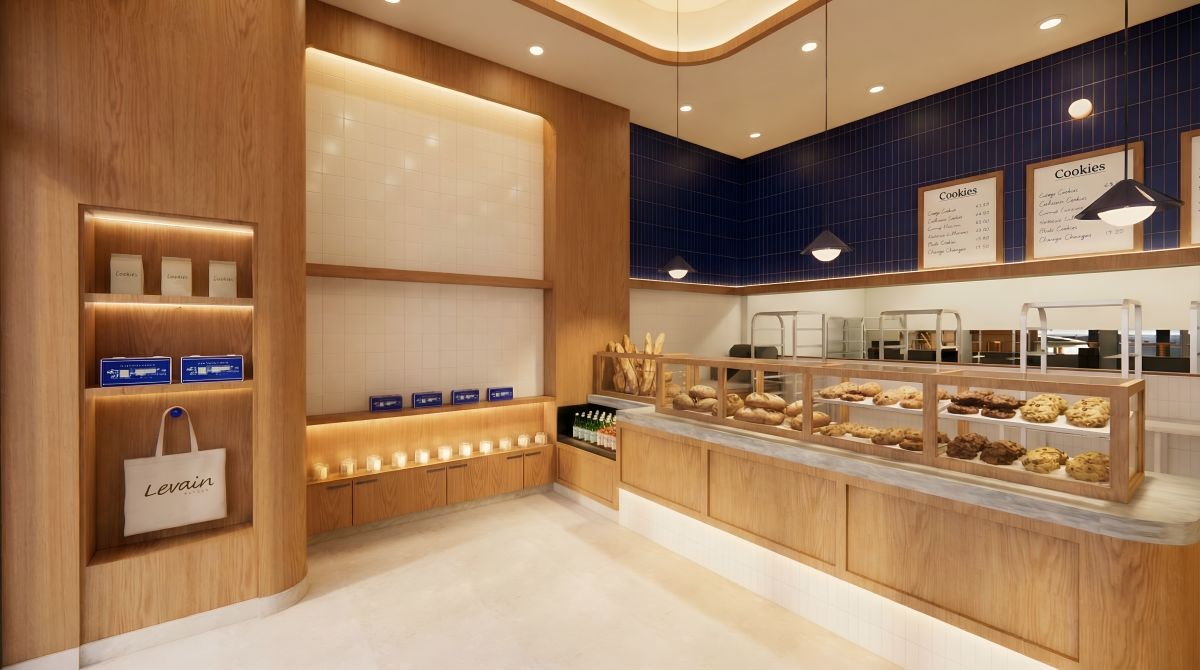 Levain Bakery interior with pastry display, blue tile walls, wood millwork, and marble counters