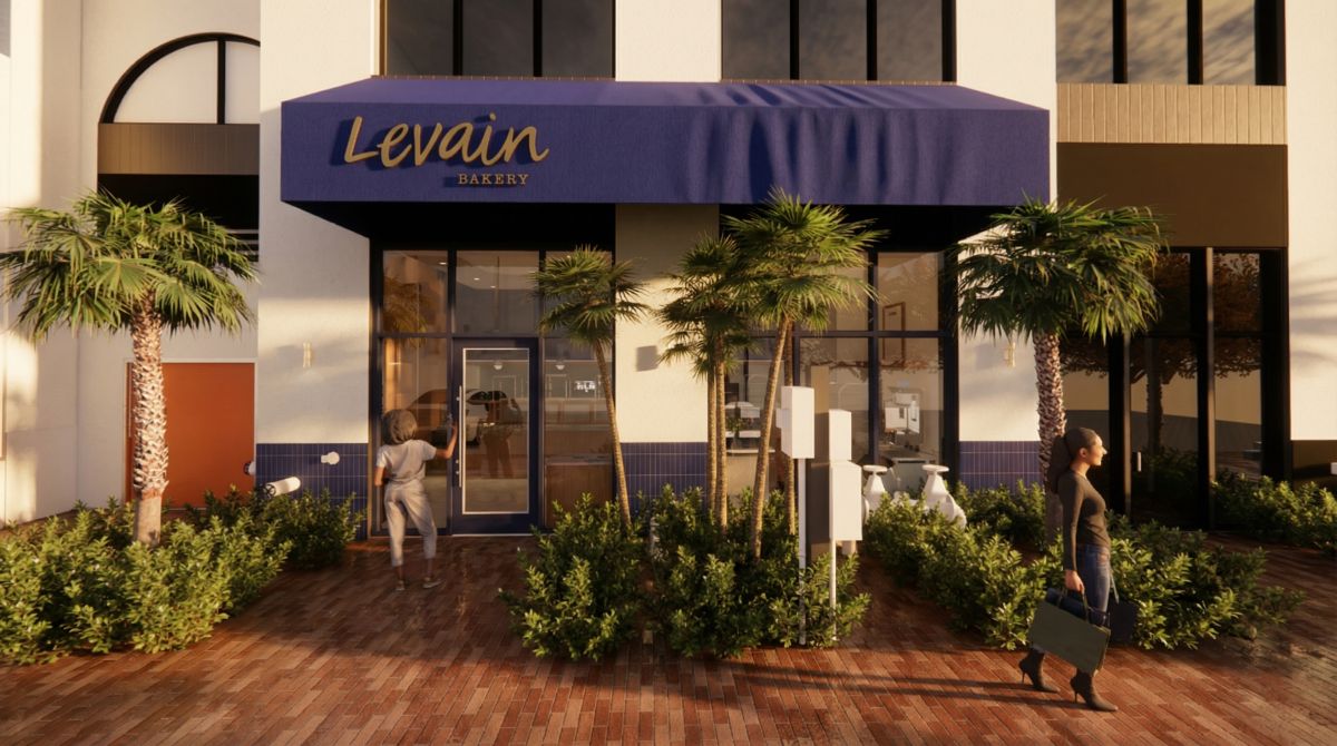 Levain Bakery storefront in Coconut Grove with blue awning, palm trees, and landscaped entry