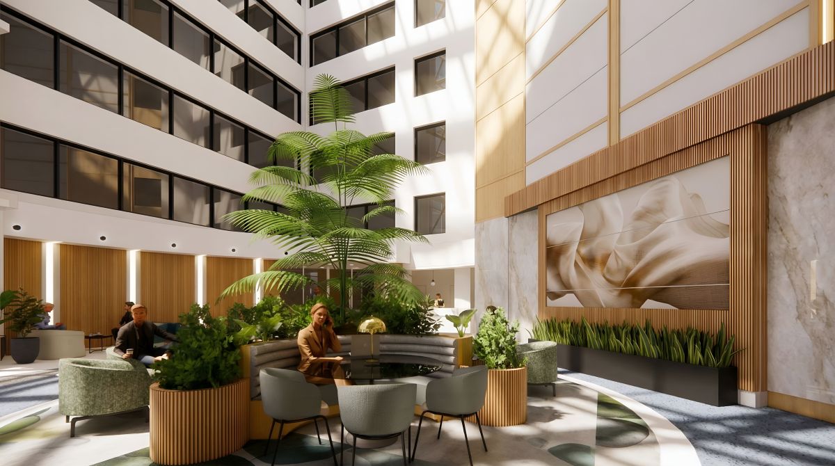 Main lobby at Boro Station Tysons VA with towering atrium, central palm tree planter and lounge seating
