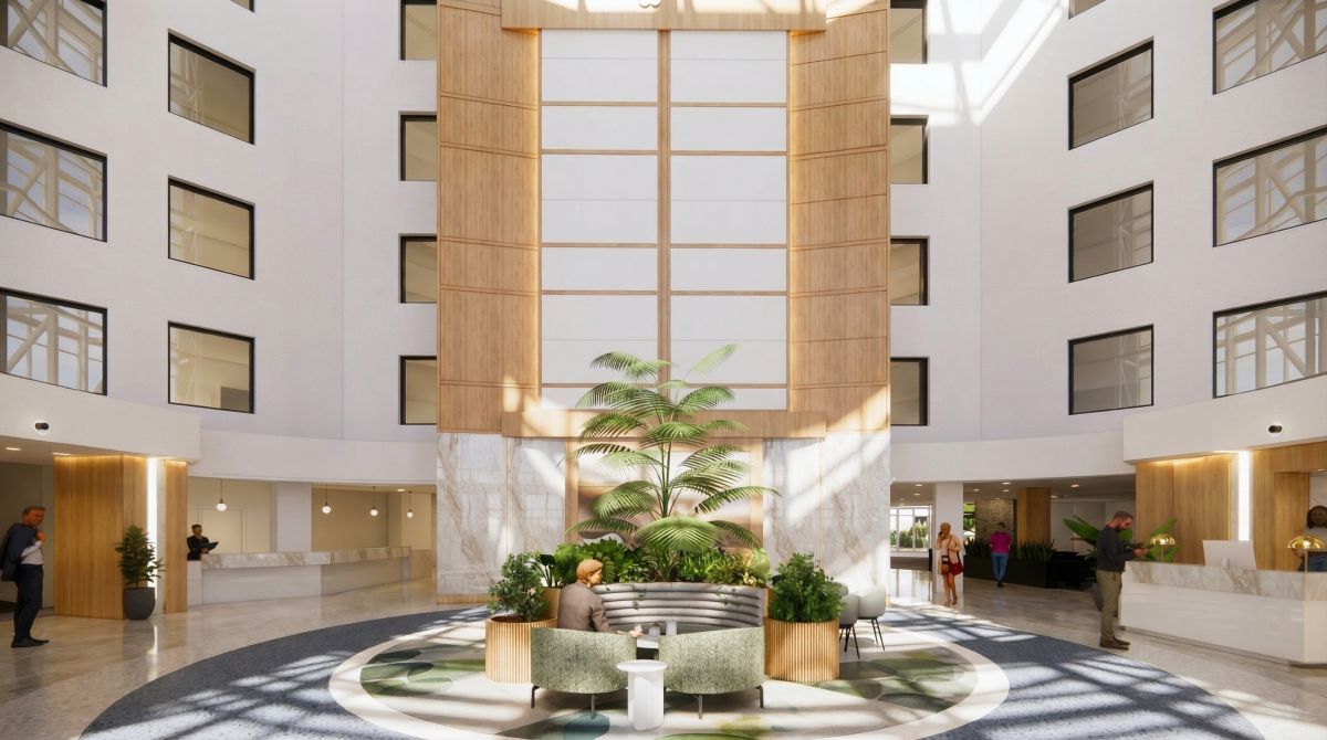 Main lobby at Boro Station Tysons VA with towering atrium, central palm tree planter and lounge seating